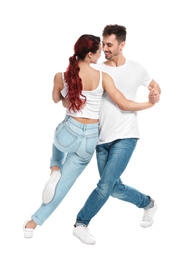 Beautiful young couple dancing on white background