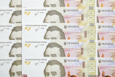 Photo of Ukrainian money as background, top view. National currency