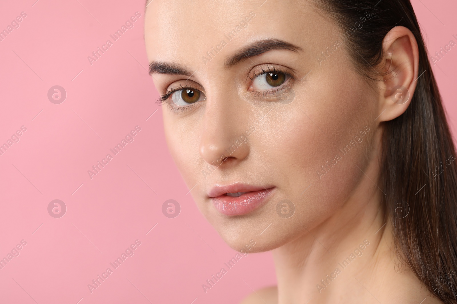 Photo of Beautiful young woman with healthy skin on pink background, closeup. Space for text