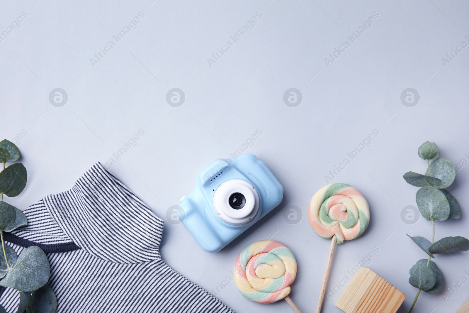 Photo of Flat lay composition with toy camera on light grey background, space for text. Future photographer