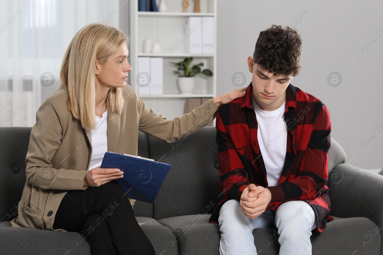 Photo of Psychologist working with teenage boy in office. Teenager problems