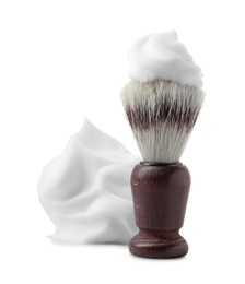 Photo of Shaving foam and brush on white background