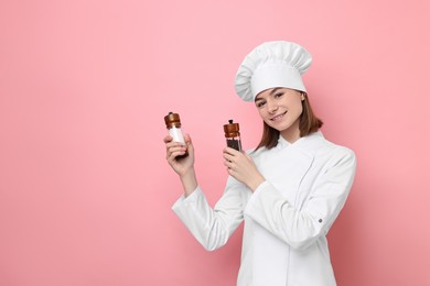 Photo of Professional chef with spices on pink background. Space for text