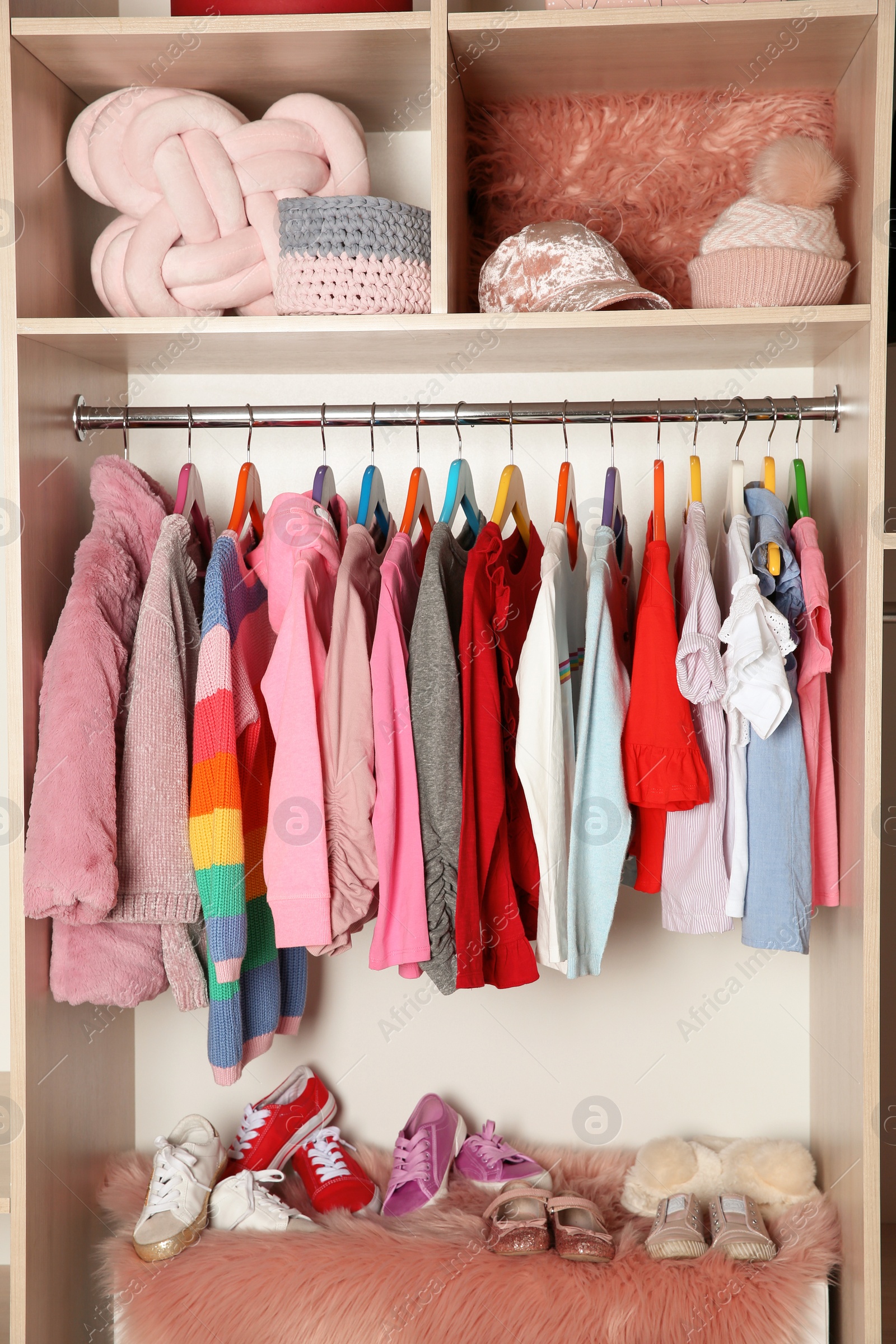 Photo of Wardrobe with stylish girl's clothes hanging on rack