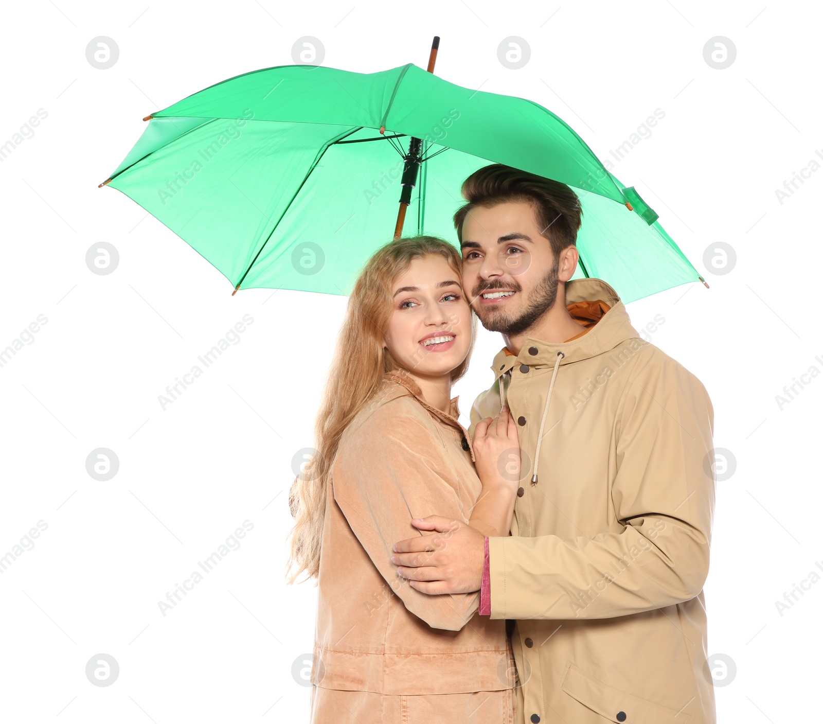 Photo of Young romantic couple with bright umbrella on white background