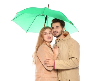 Young romantic couple with bright umbrella on white background