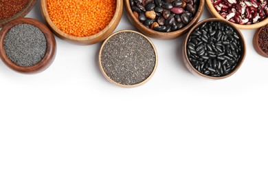 Various raw veggie seeds in bowls on white background, top view