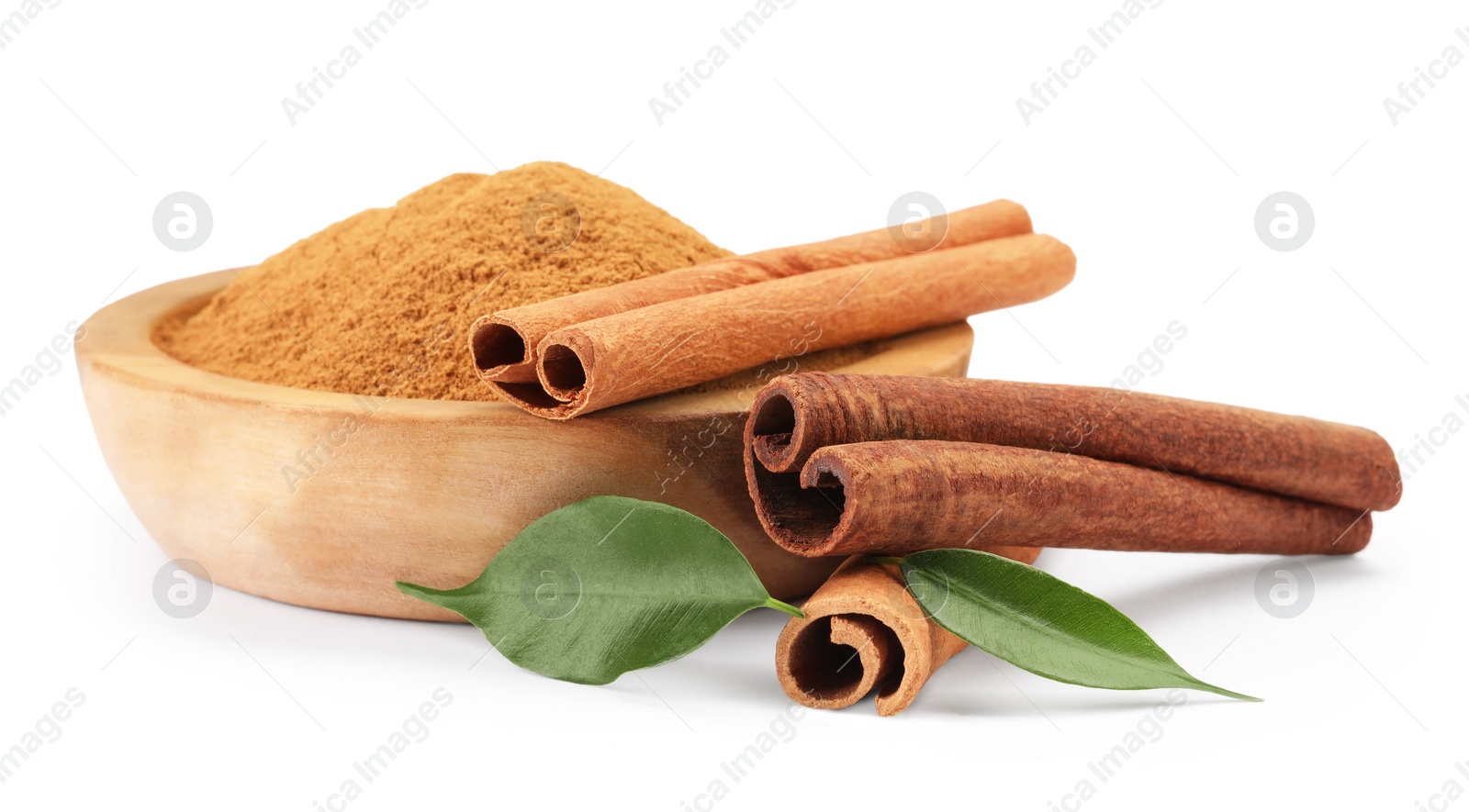 Photo of Dry aromatic cinnamon sticks, powder and green leaves isolated on white