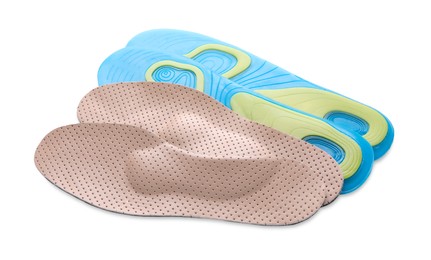 Photo of LIght blue and beige orthopedic insoles on white background