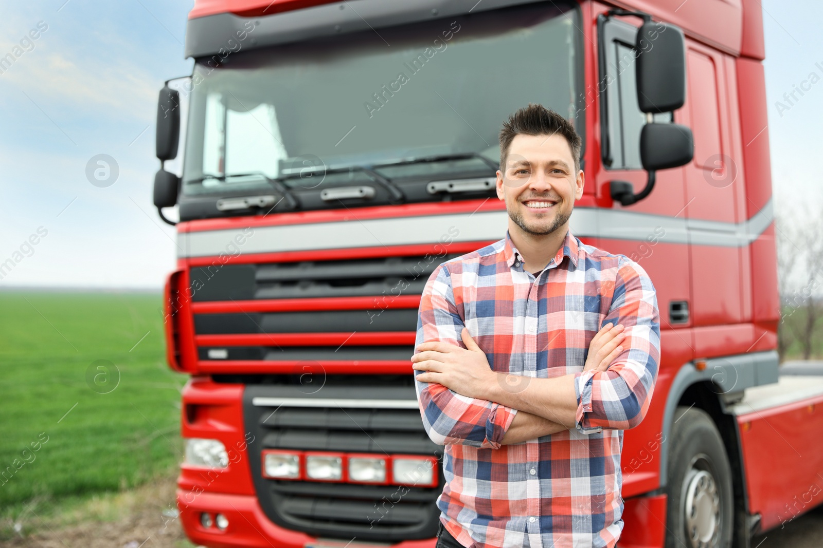 Photo of Portrait of driver at modern truck outdoors