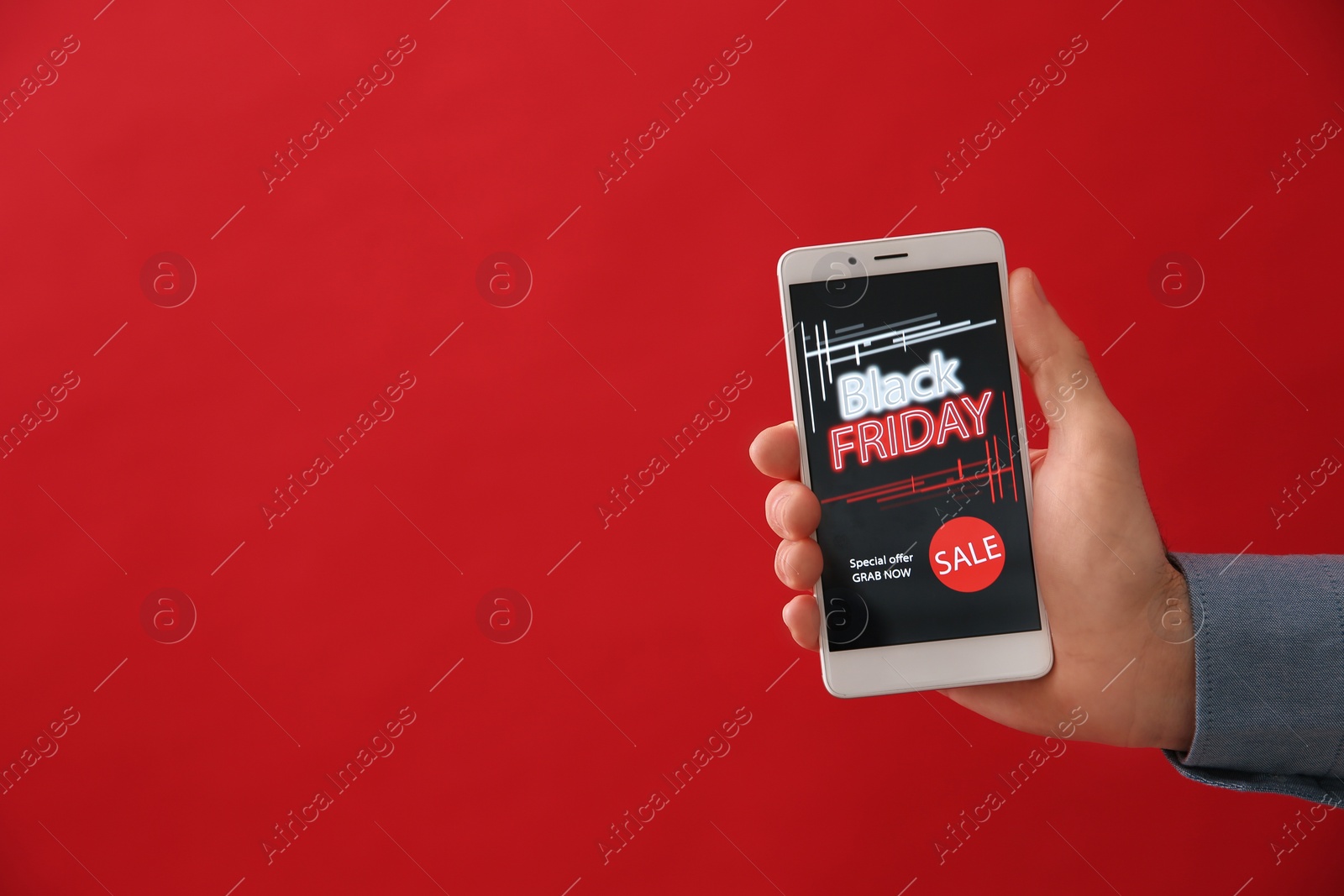 Photo of Man shopping online using smartphone on red background, space for text. Black Friday Sale
