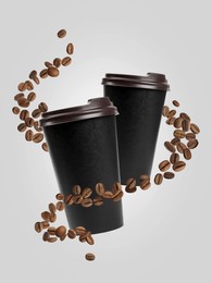 Image of Coffee to go. Paper cups and roasted beans flying on light background