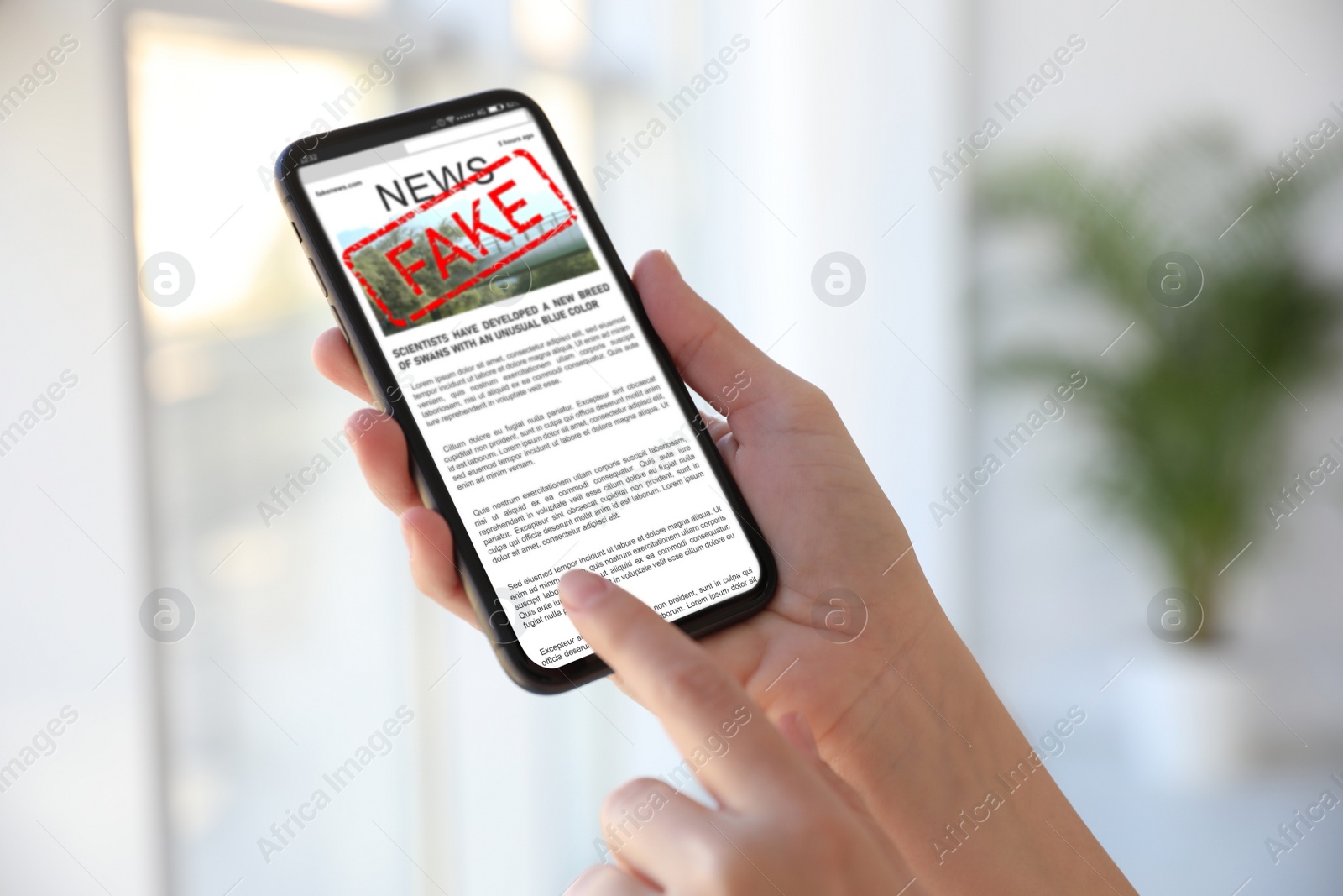 Image of Fake information. Woman using mobile phone to read news at home, closeup