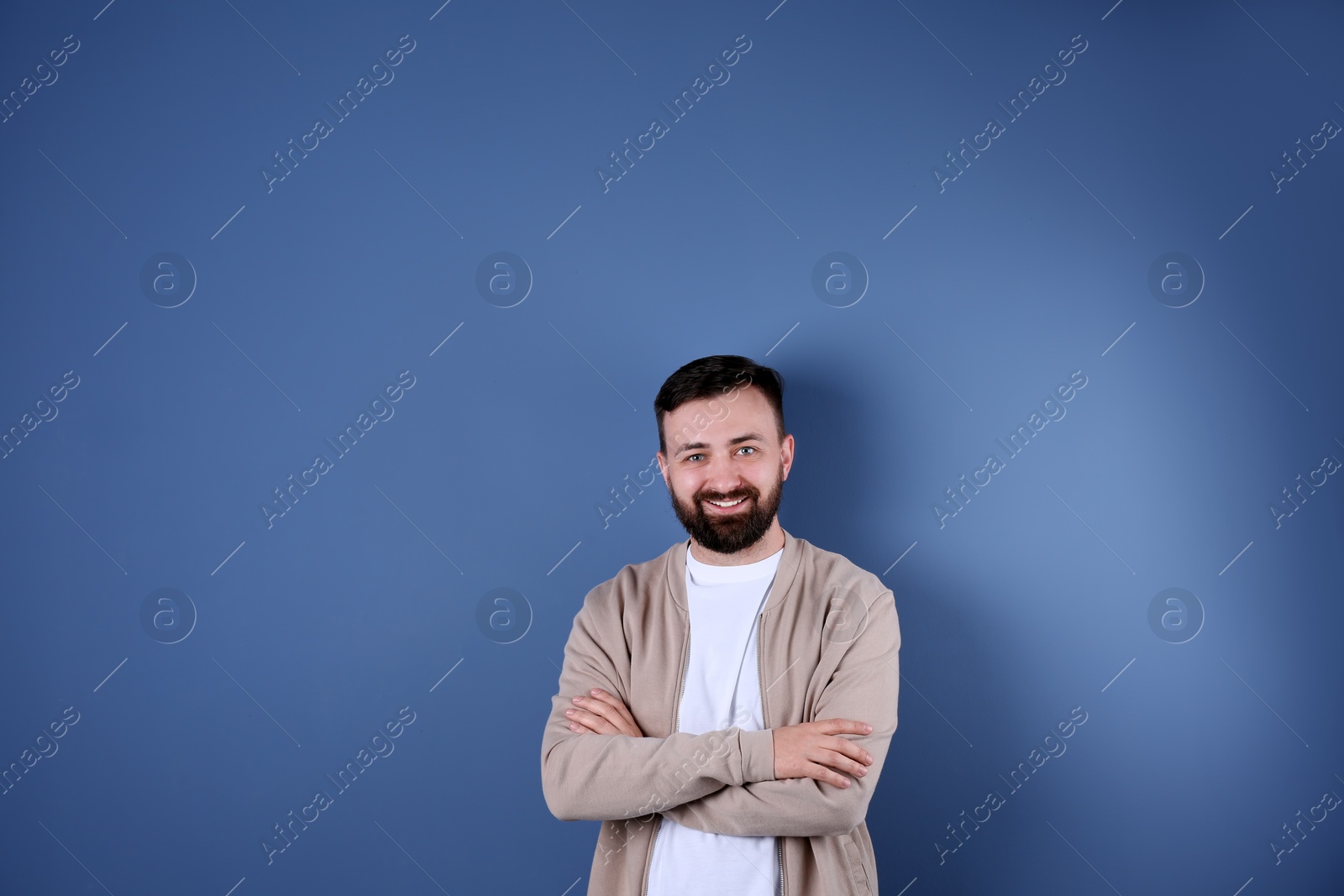 Photo of Portrait of handsome bearded man on color background