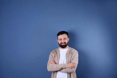 Photo of Portrait of handsome bearded man on color background