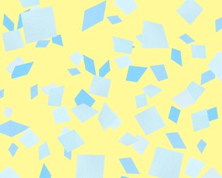 Bright confetti falling on yellow background. Party supply