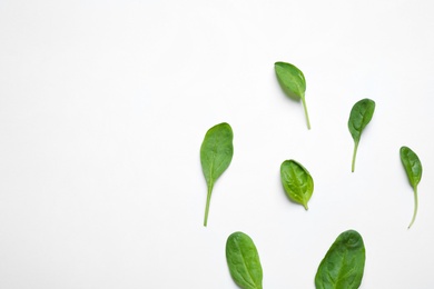 Photo of Fresh green healthy spinach on white background, top view