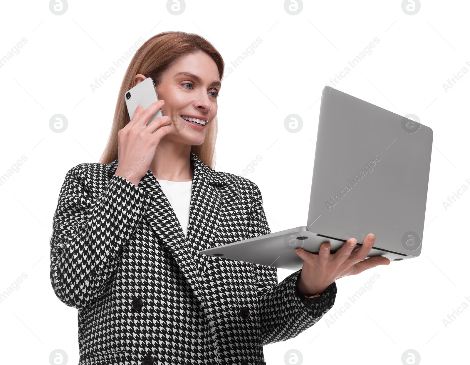 Photo of Beautiful happy businesswoman with laptop talking on smartphone against white background