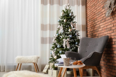 Stylish living room interior with decorated Christmas tree