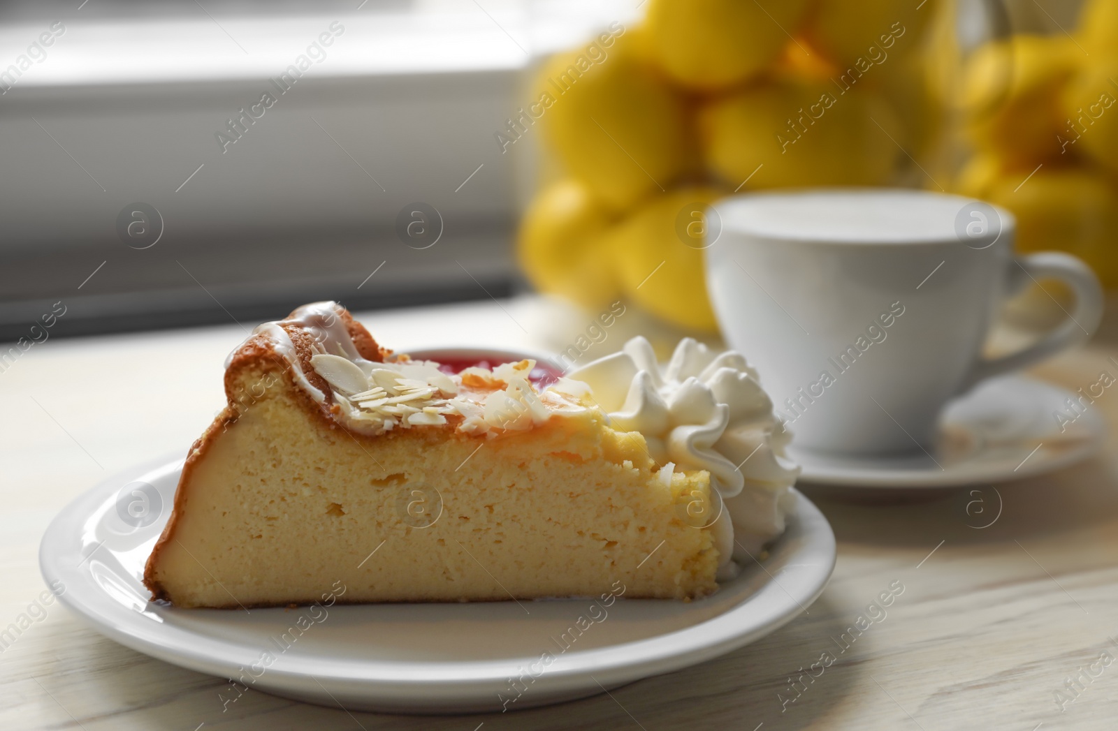 Photo of Piece of delicious cake and hot drink on white wooden table, closeup