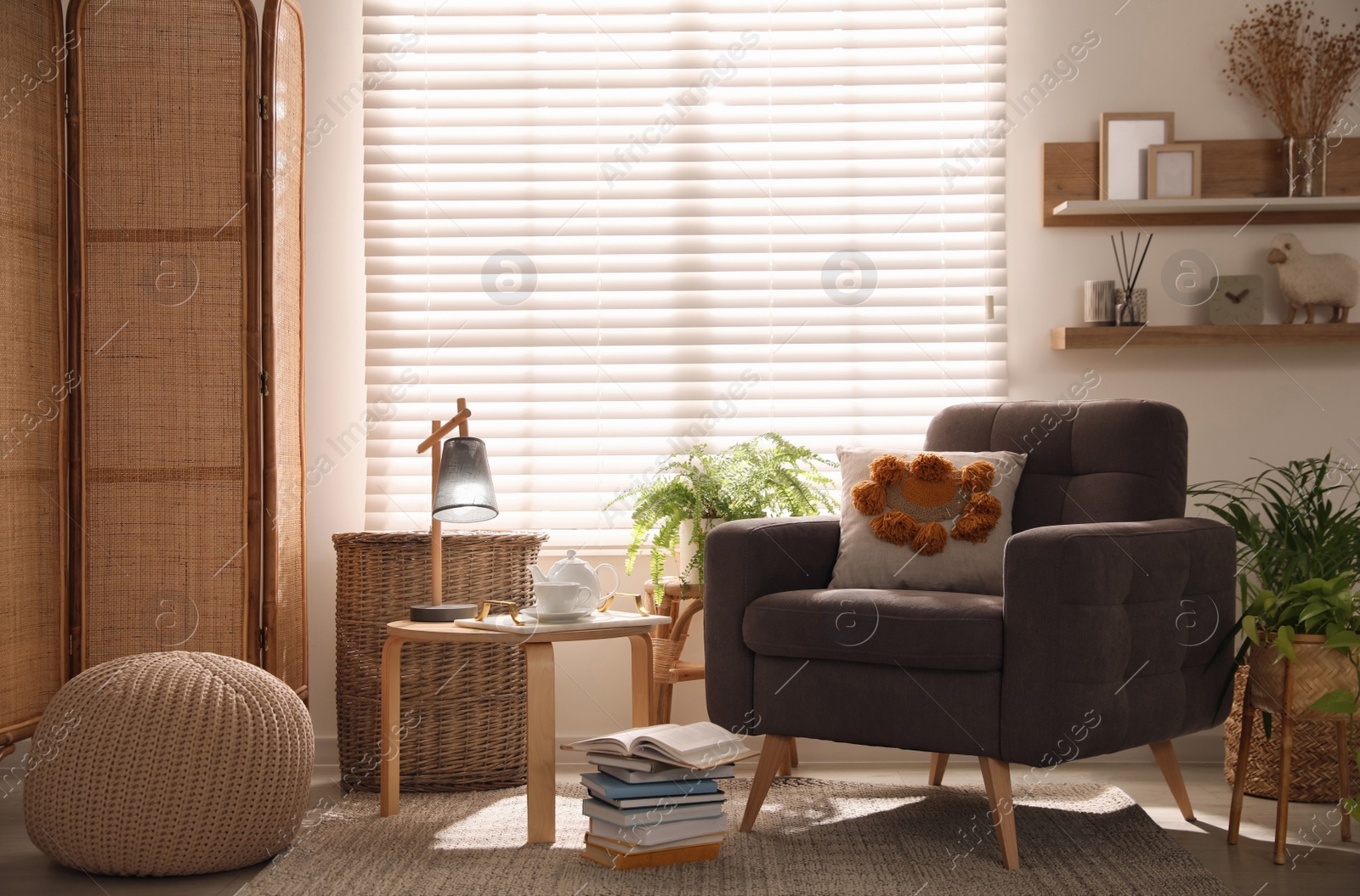 Photo of Comfortable place for rest with armchair near window in room