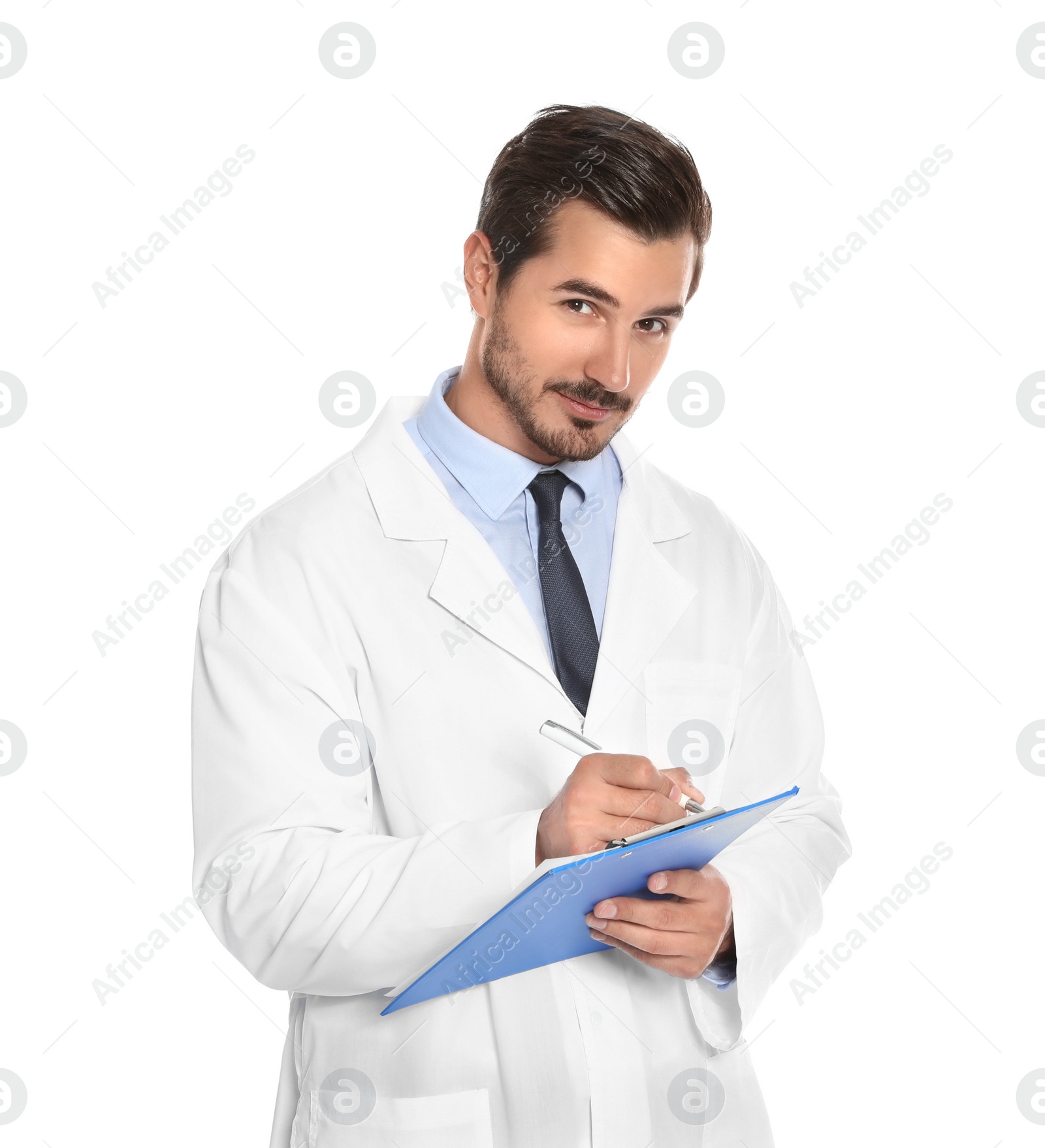 Photo of Young male doctor writing on clipboard against white background. Medical service