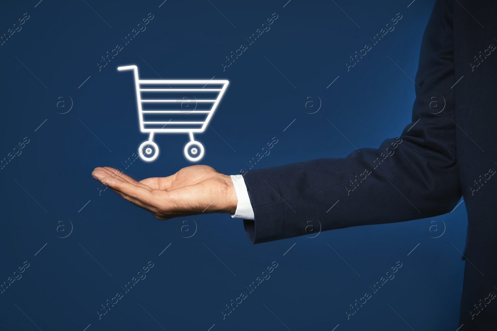 Image of Man demonstrating virtual image of shopping cart on blue background, closeup