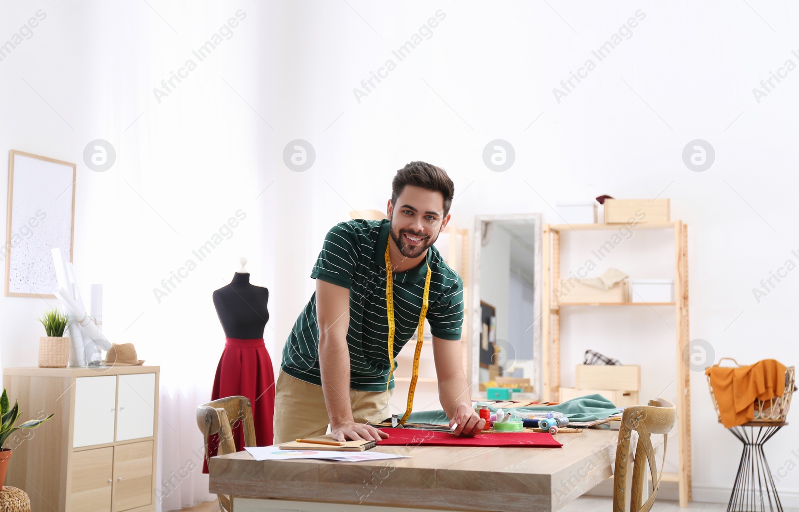 Photo of Fashion designer creating new clothes in studio