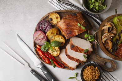 Photo of Delicious grilled meat and vegetables served on light grey table, flat lay