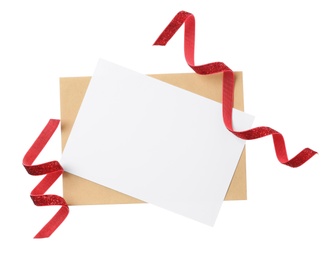 Photo of Blank card, envelope and red ribbons on white background, top view. Valentine's Day celebration