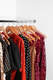 Photo of Collection of different beautiful women's party dresses on hangers in showroom. Stylish trendy clothes for high school prom