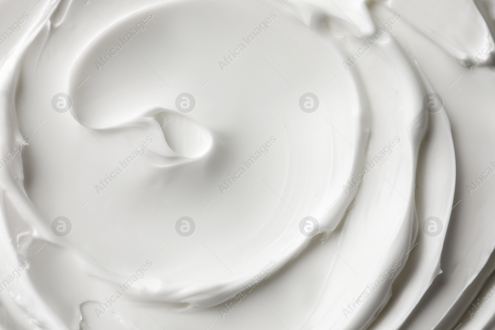 Photo of Texture of white face cream as background, top view