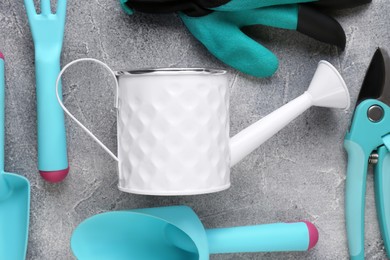 Photo of Flat lay composition with watering can and gardening tools on light grey background