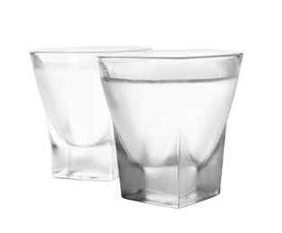 Photo of Vodka in shot glasses on white background