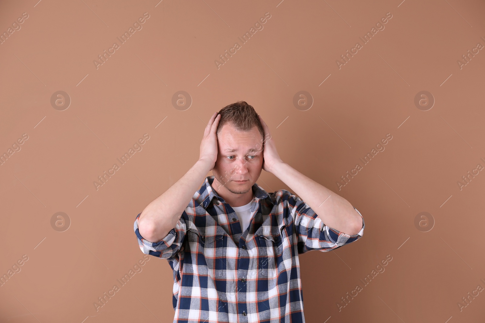 Photo of Portrait of handsome man suffering from headache on color background
