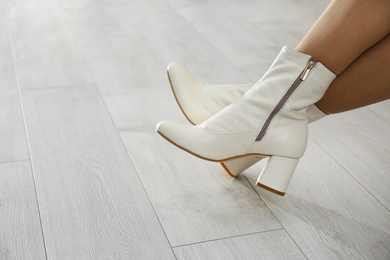 Woman wearing stylish leather shoes indoors, closeup. Space for text