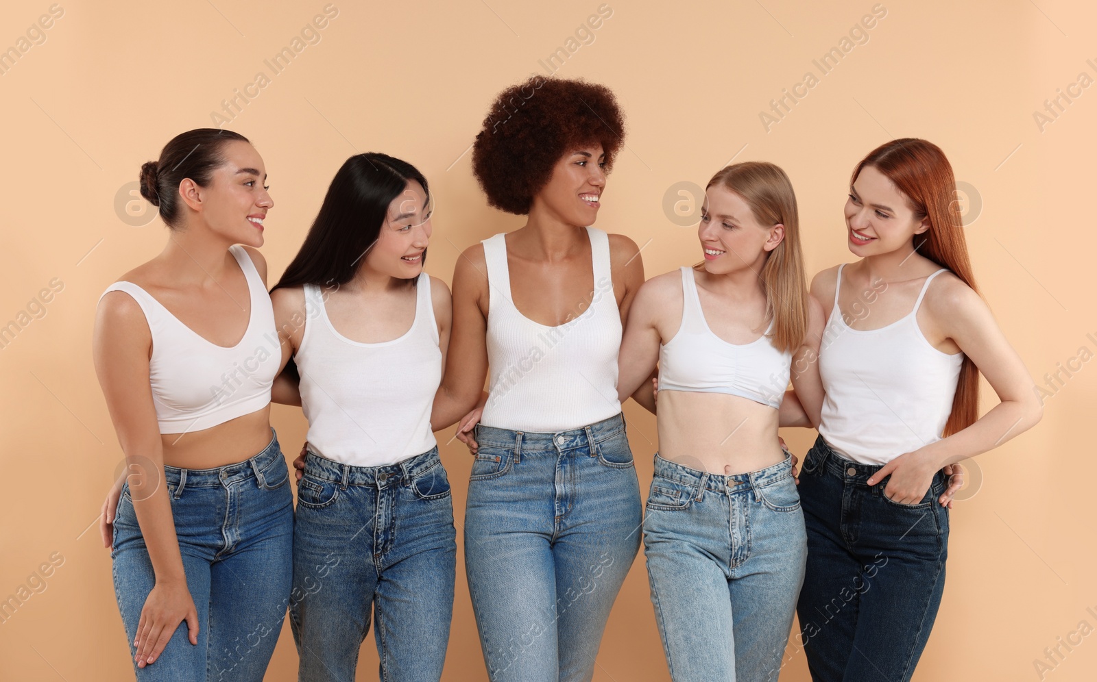 Photo of Group of beautiful young women on beige background