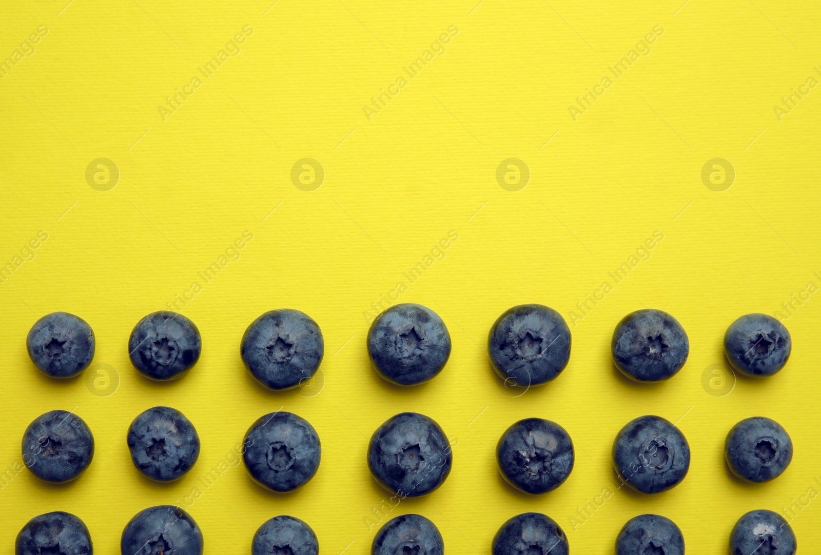 Photo of Flat lay composition with tasty blueberry and space for text on color background