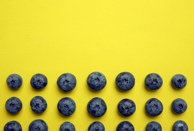 Photo of Flat lay composition with tasty blueberry and space for text on color background