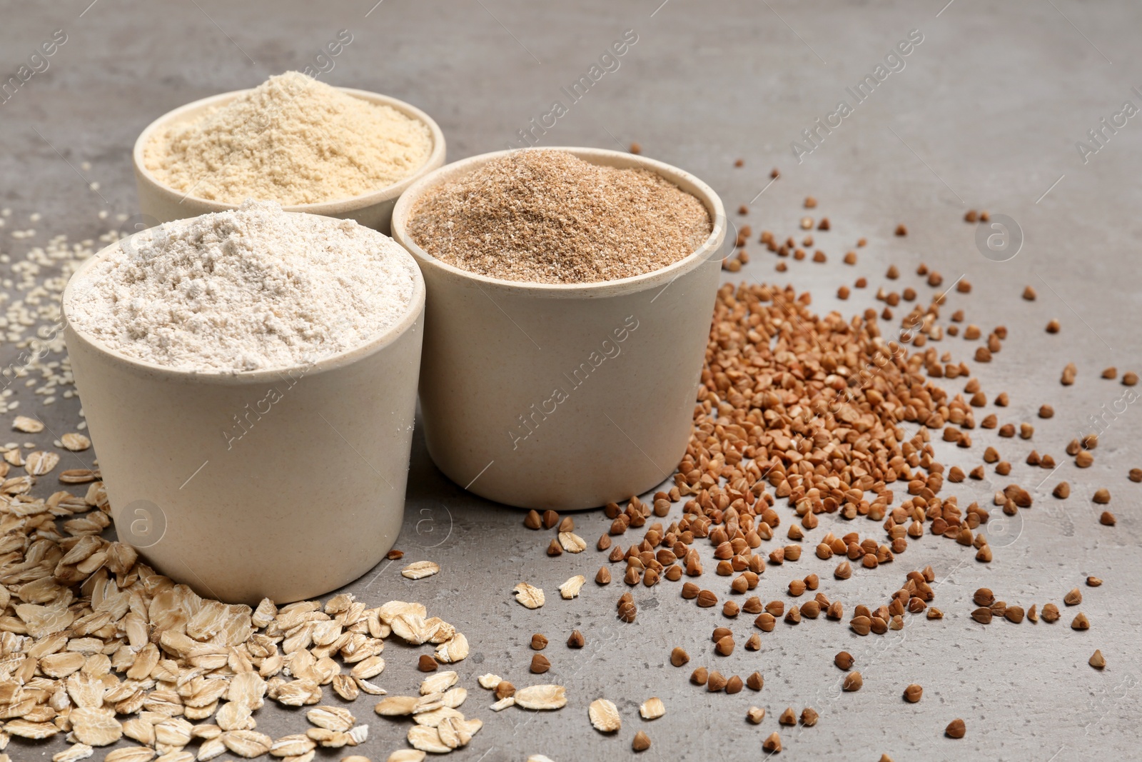 Photo of Composition with different types of flour on grey background