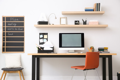 Modern computer on table in office interior. Stylish workplace