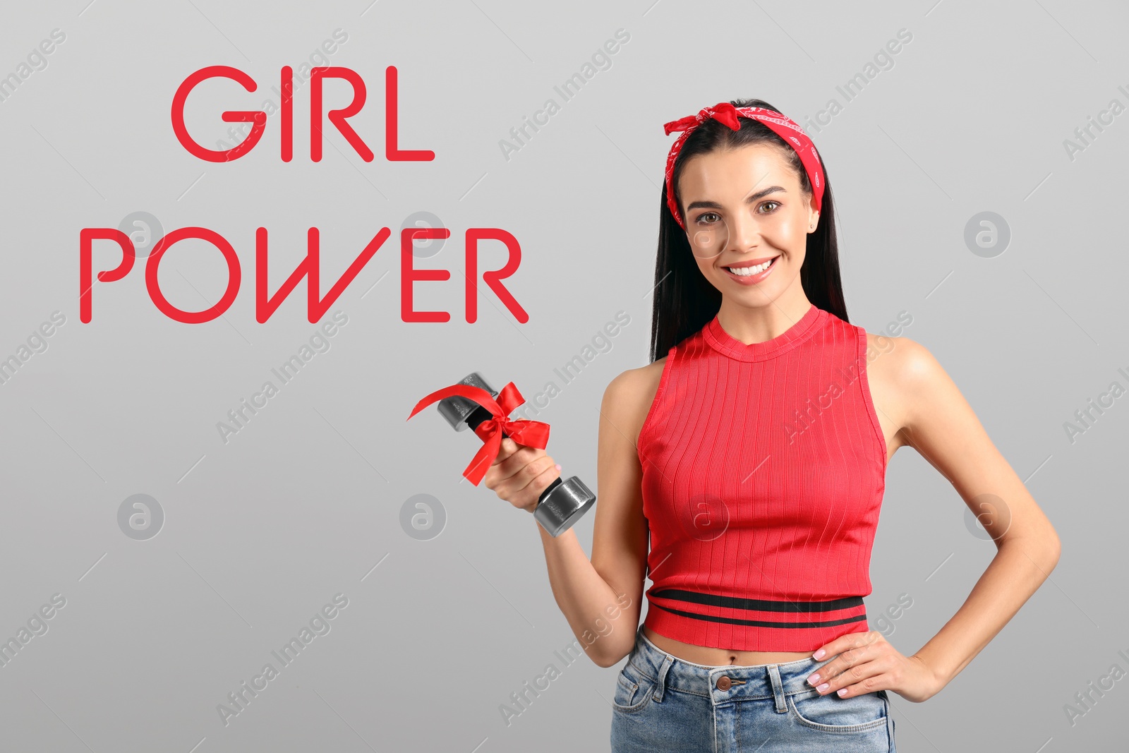 Image of 8 March greeting card. Phrase Girl Power and young woman holding dumbbell on light background