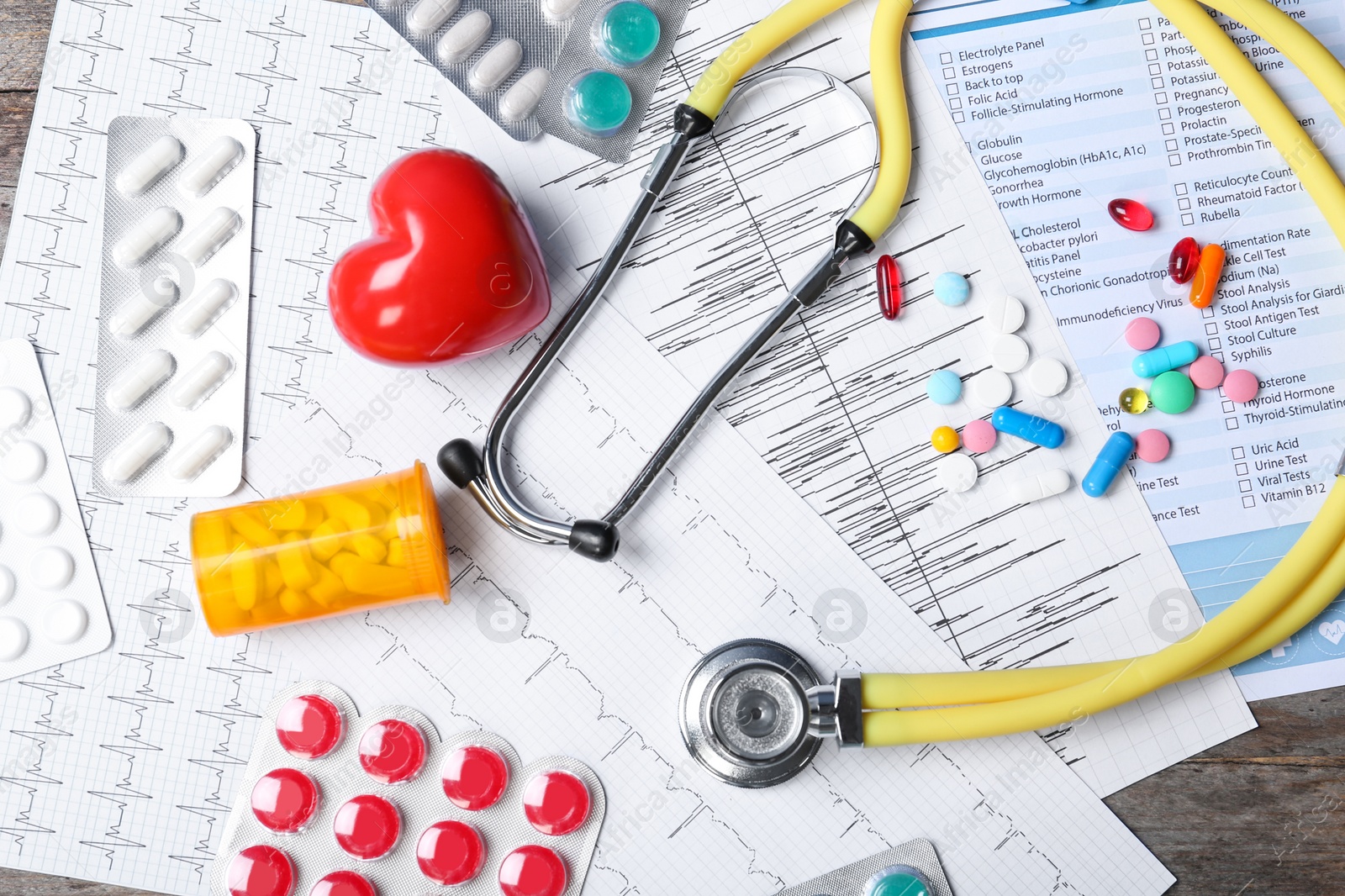 Photo of Flat lay composition with stethoscope and pills on table. Cardiology service
