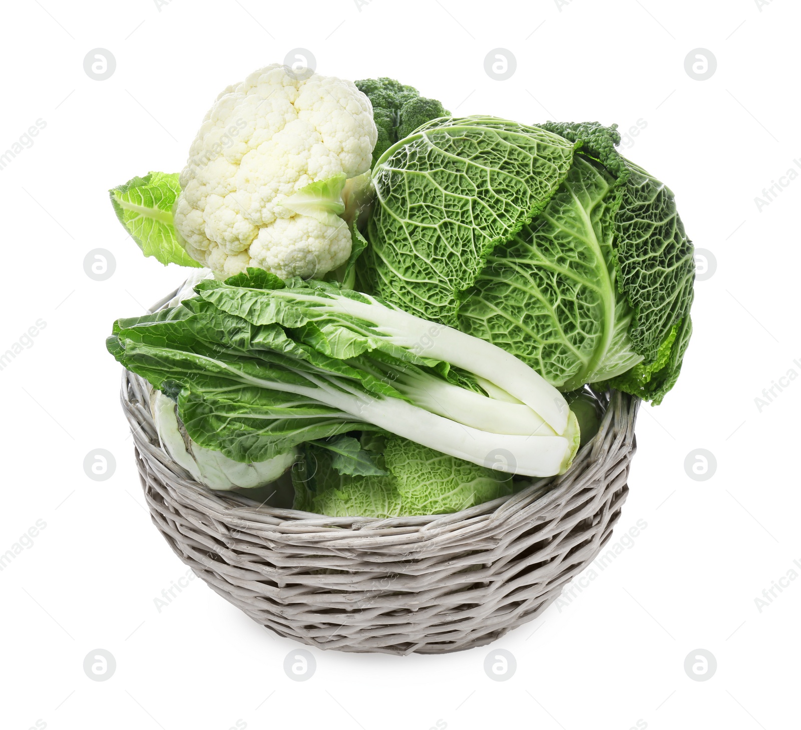 Photo of Wicker basket with different types of fresh cabbage on white background