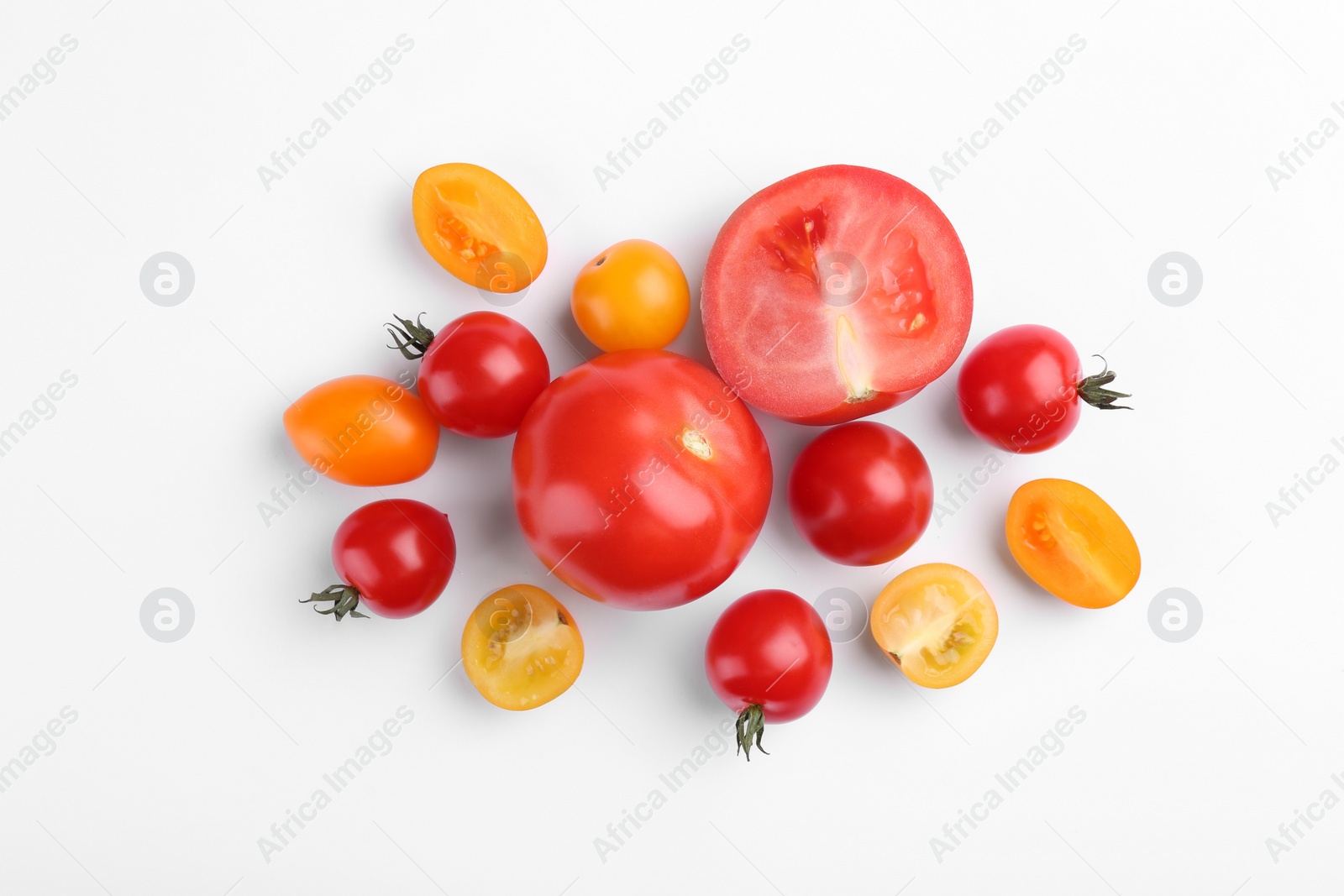 Photo of Flat lay composition with different whole and cut tomatoes on white background