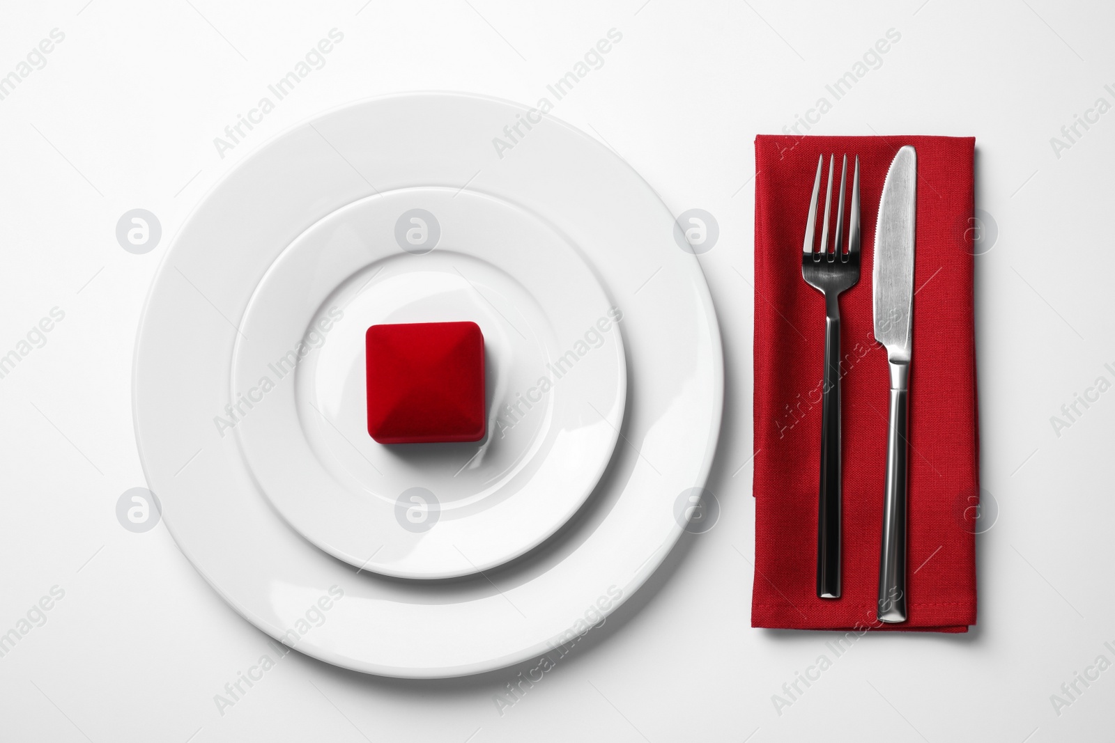 Photo of Beautiful table setting with gift box for romantic dinner on white background, flat lay