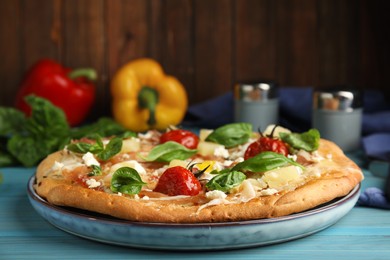 Photo of Delicious homemade pita pizza on light blue wooden table