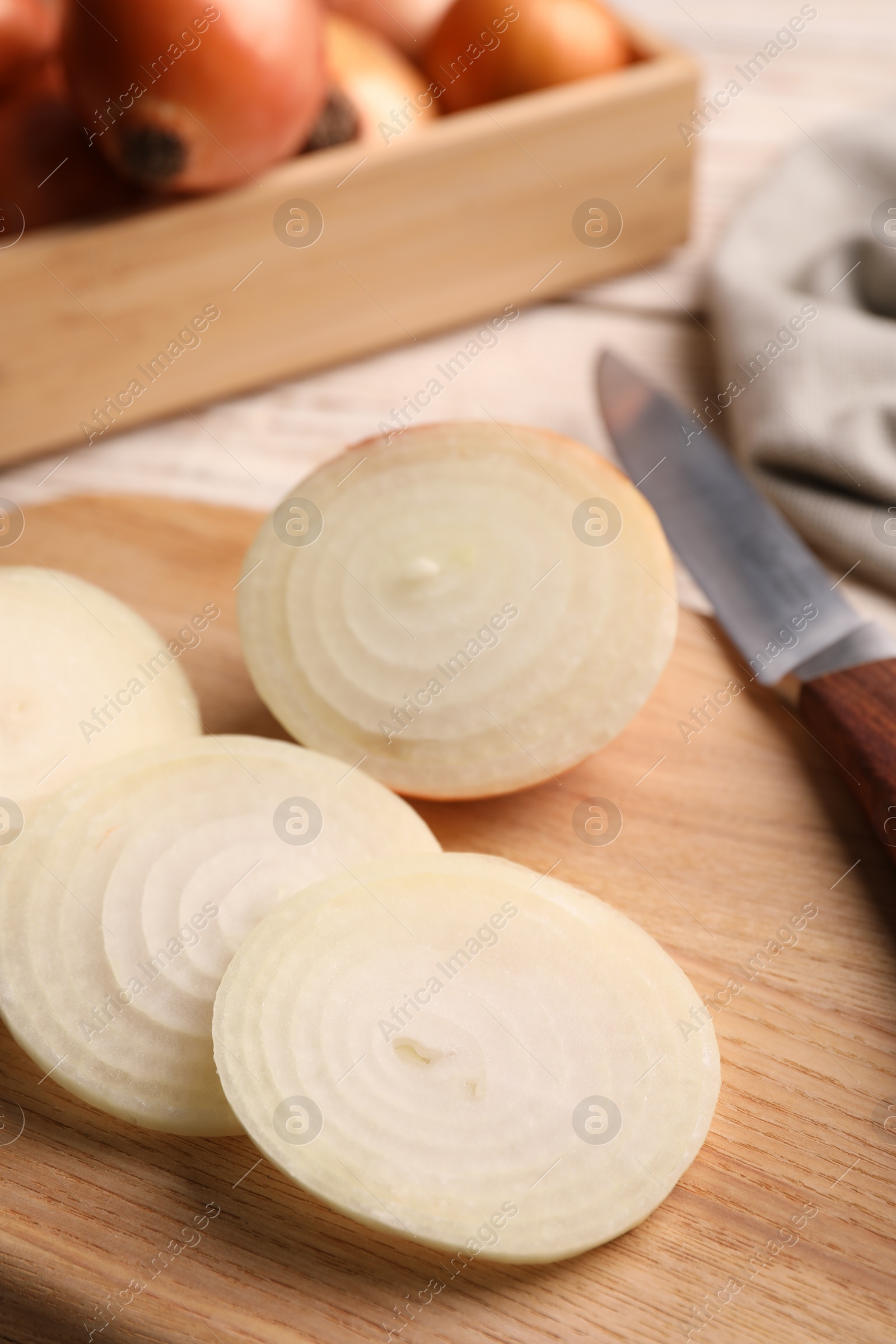 Photo of Sliced fresh onion on wooden table, closeup