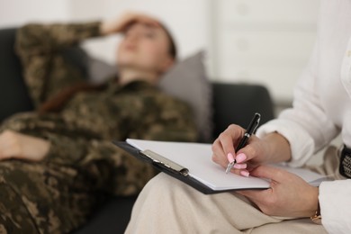Psychotherapist working with military woman in office, closeup