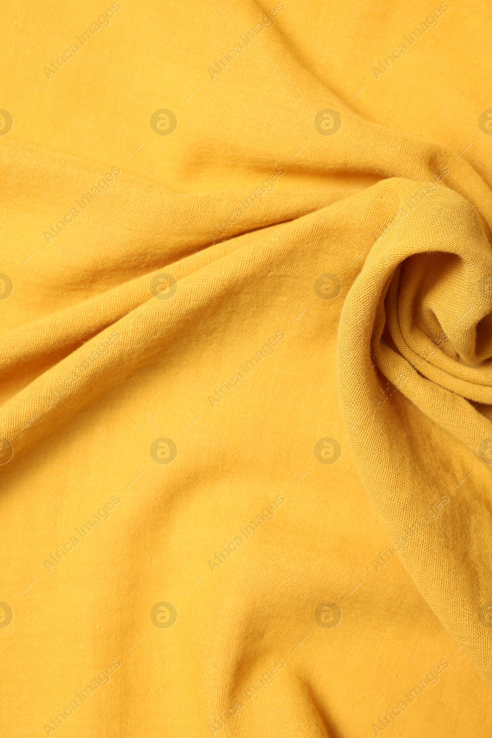 Photo of Texture of soft yellow crumpled fabric as background, top view